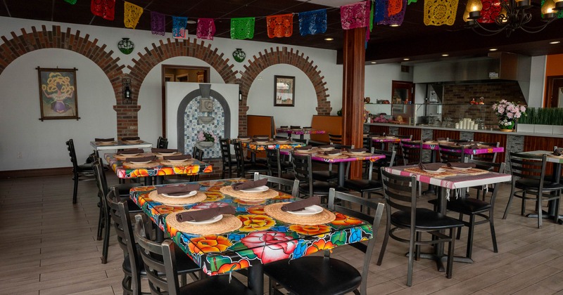 Interior of a colorful restaurant with floral tablecloths