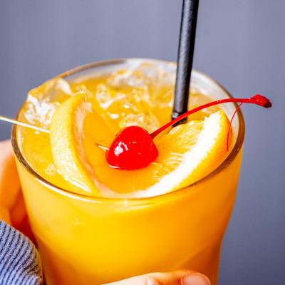 A hand holding the Mai Tai.