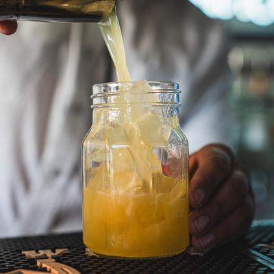 Bartender pouring a cocktail.
