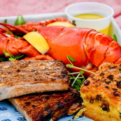Lobster with half rack of smoked ribs, cornbread and dressing