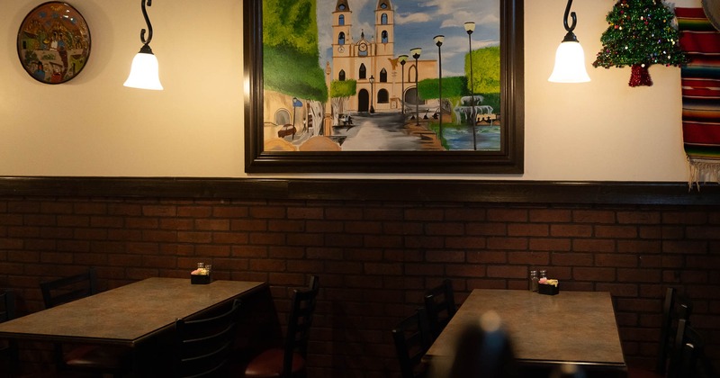 Interior, tables and chairs with picture on the wall