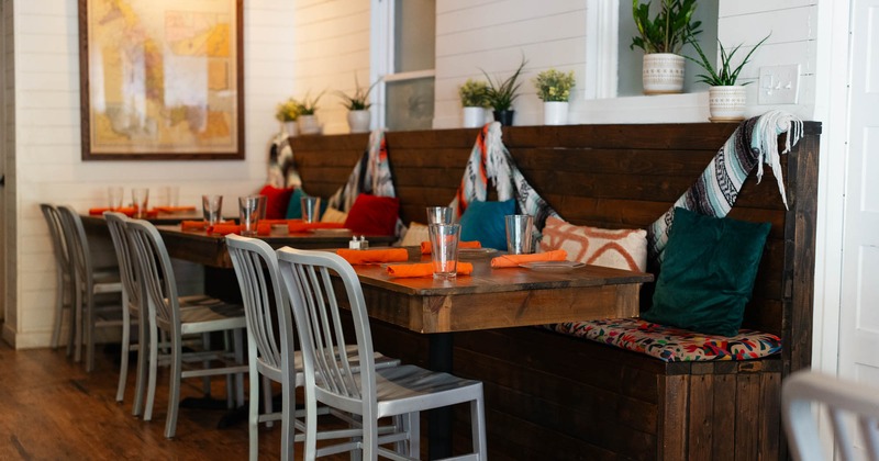 Interior, dining area, wooden top tables for four, banquette bench