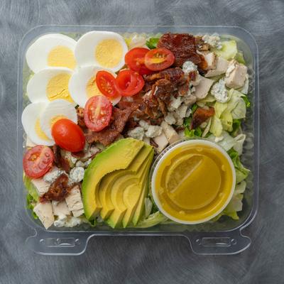 Cobb salad with house made mustard vinaigrette dressing, top view.