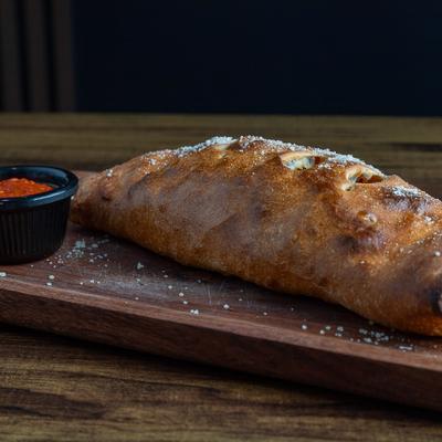 Meat lover roll with marinara on the side.