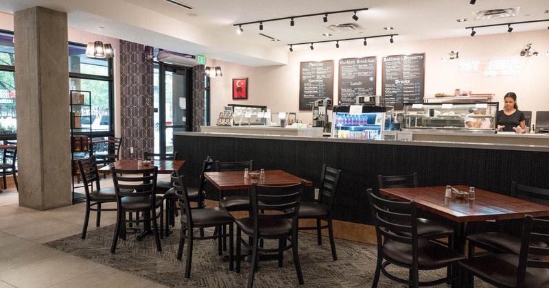 Interior, tables ready for guests, order counter in the back