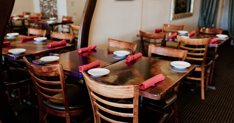 Interior, dining tables and chairs ready for guests