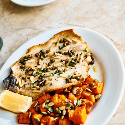 Fish fillet with capers, almonds, and butternut squash.