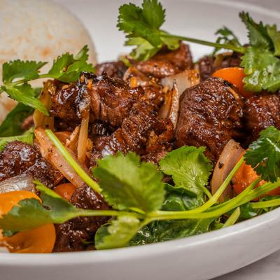 Shaking beef tenderloin, salad and rice.