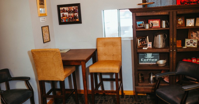 Table with bar stools in the corner of the room