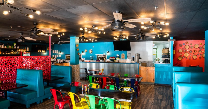Interior, view of dining area, bar in the back