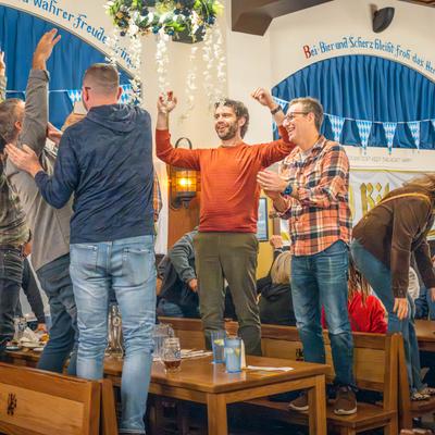 A group of cheerful guests having fun in seating area.