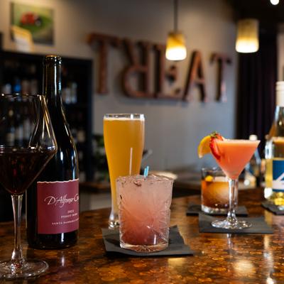 Various cocktails served on the table alongside beer and red wine.