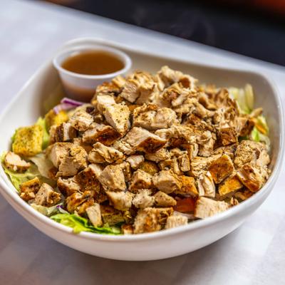Grilled Chicken Salad with a cup of dressing.