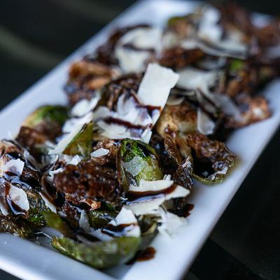 Fried Brussels sprouts with balsamic glaze and shaved Parmesan.