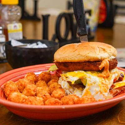 Chipotle chicken sandwich served with tater tots.