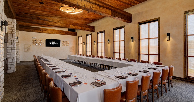 Interior, banquet room, long tables with white cloth, glasses and cutlery