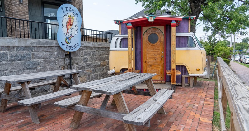 Exterior, seating area, wooden tables with benches,  bricks as flooring