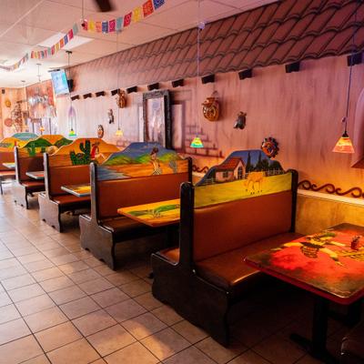 Restaurant booths with colorful painted tables and decor.