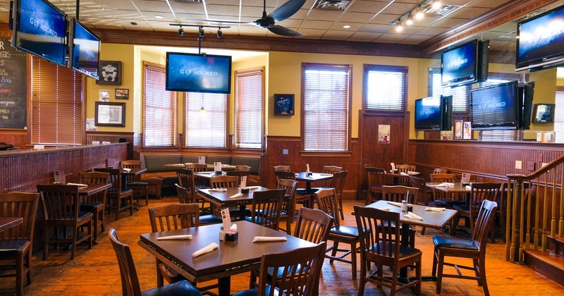 Interior, dining area with TV's above tables