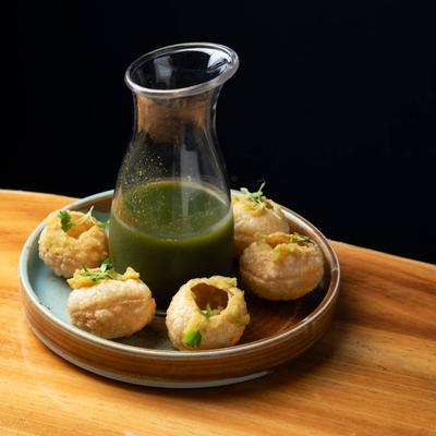 Deep fried breaded spheres, with mint water.