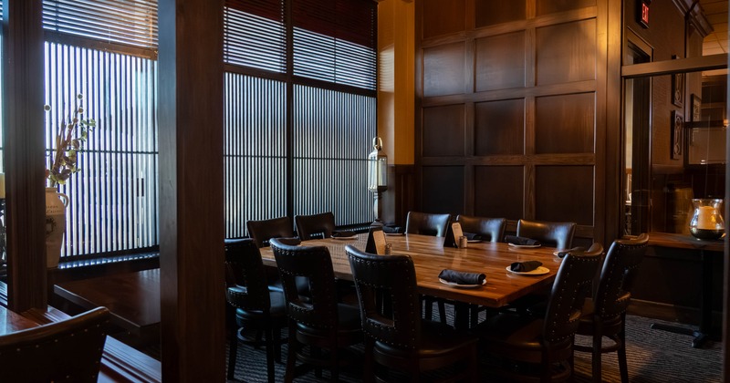 Interior, private dining area, wooden top table for ten people, carpet flooring