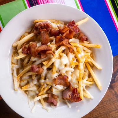 Fries smothered in melted cheese and topped with savory bacon bits.