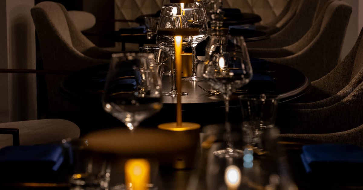 Dim dining table set with candles and glassware