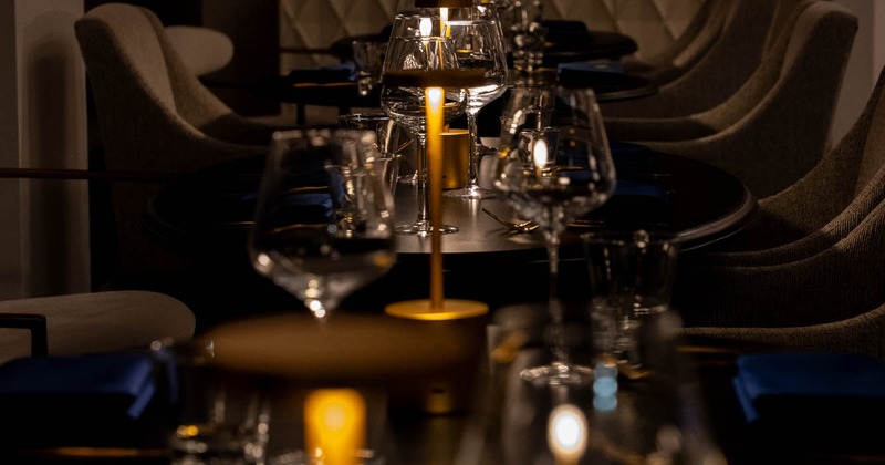 Dim dining table set with candles and glassware