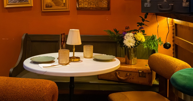 Round table set for two guests in the corner