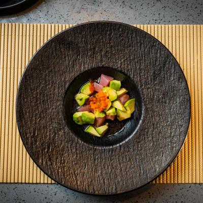 Overhead view of tuna ceviche with avocado and fish roe topping.