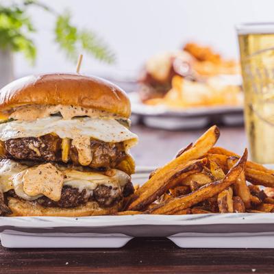 No Bull double burger served with fries and a glass of beer