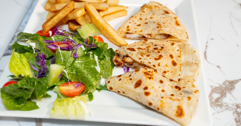 Shrimp quesadillas, served with salad, and fries