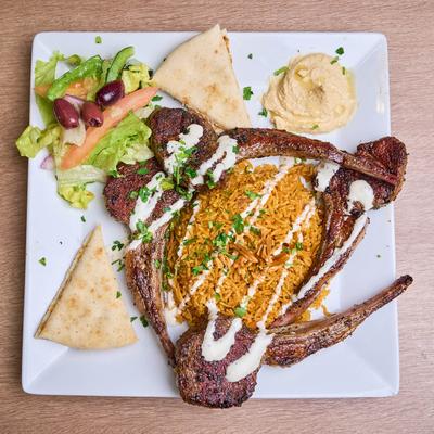 Lamb Chops with rice, pita, salad and hummus.