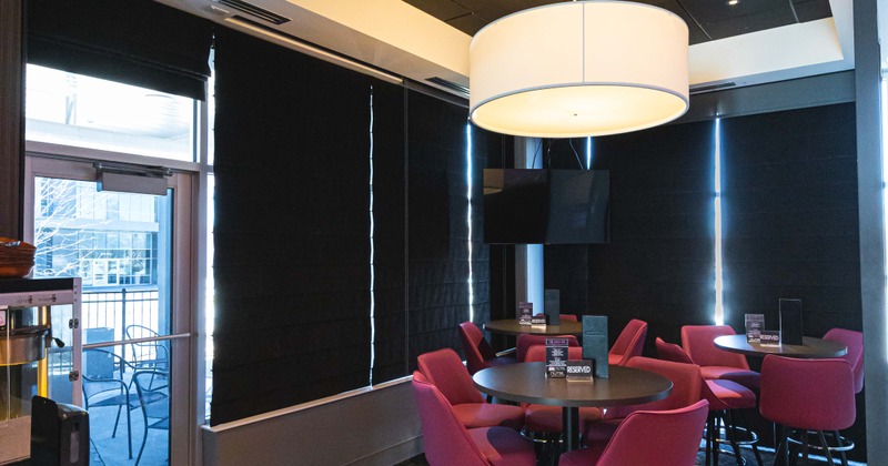 Interior, tables and seats near a door to outdoor seating area