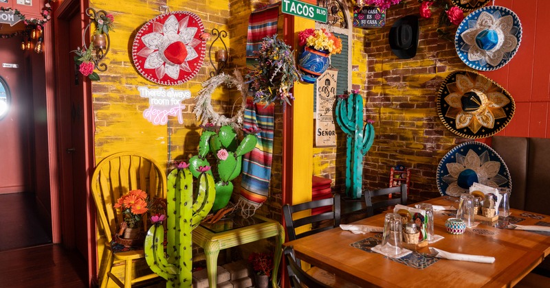Restaurant corner - a dining table next to a wall decorated in Mexican style