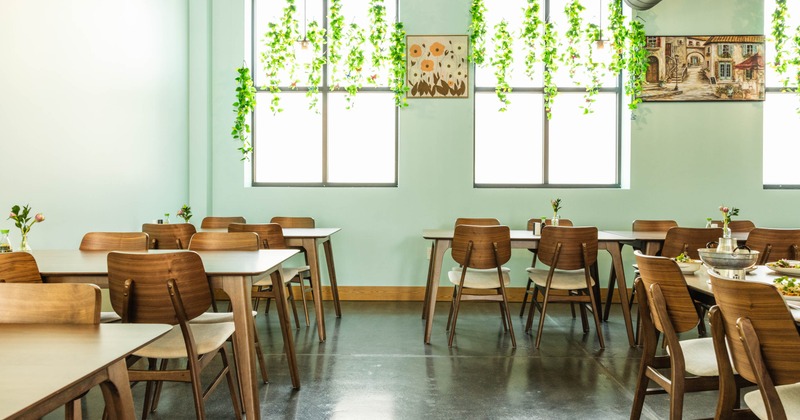 Interior, dining area, tables with chairs, ready for guests, mint green pastel walls