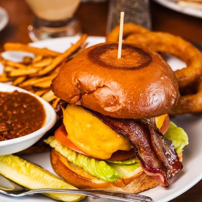 Tubby Hook burger served with fries, onion rings, and a side of chili.