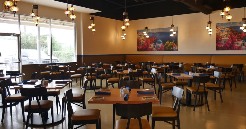 Interior of spacious dining area with set dining tables