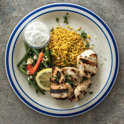 Grilled chicken kebab, with rice and salad.
