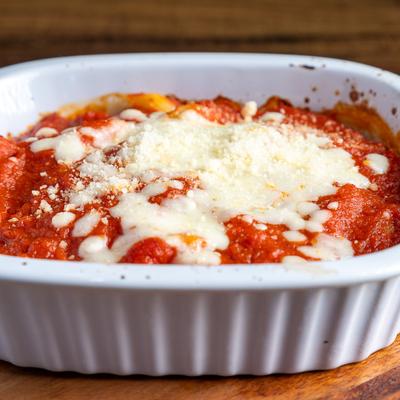 Baked ziti in a white ceramic baking dish.