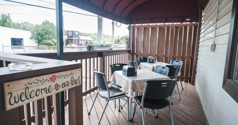 Exterior, covered seating area with tables and chairs