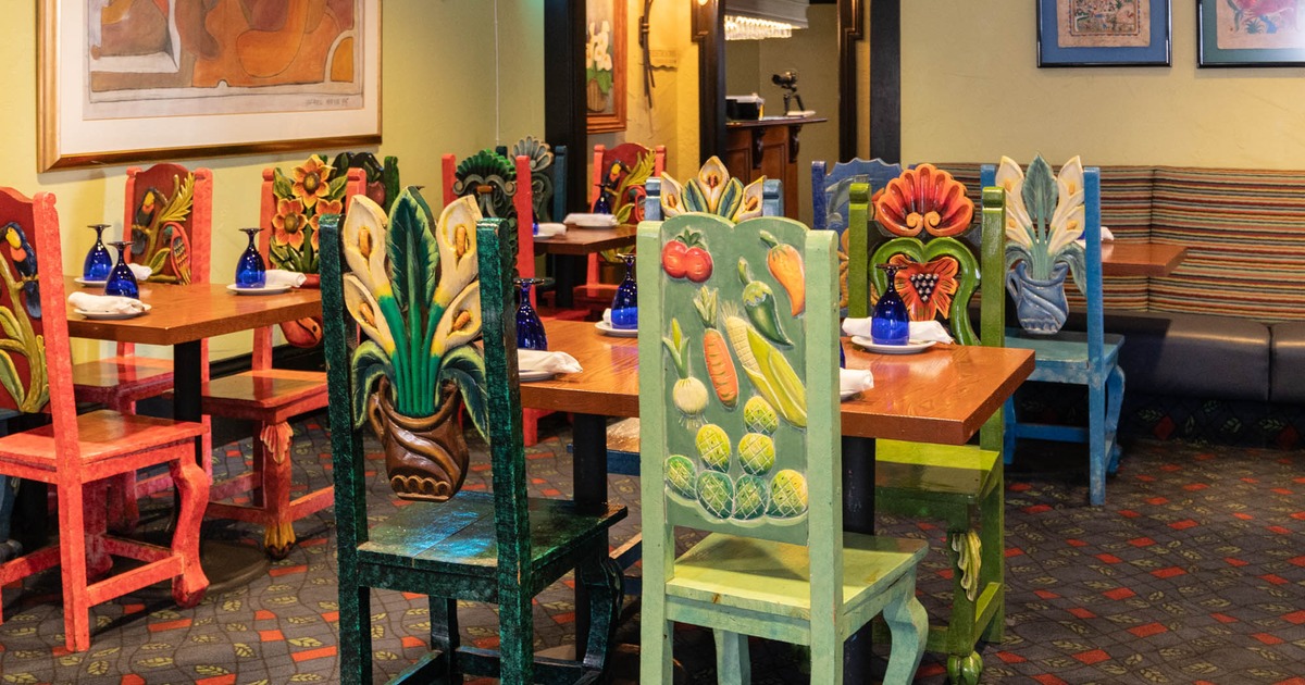Dining tables, colorful hand carved chairs