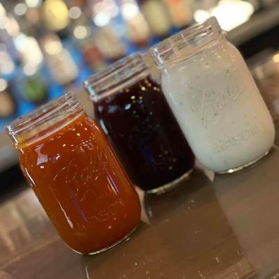 3 Mason Jars filled with a variety of our wing sauces and ranch dressing.