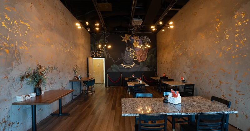 Interior, tables and chairs with painted wall in background