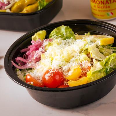 Caesar salad served in a takeout bowl.