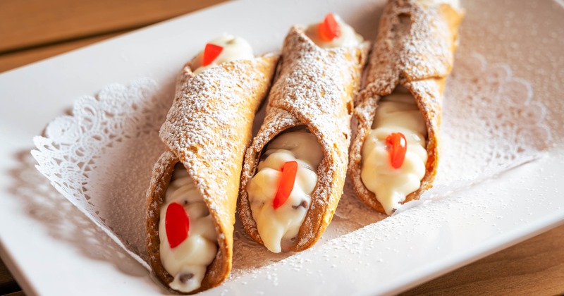 Three cannoli on a plate