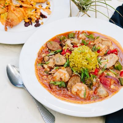 Seafood gumbo with shrimp, oysters, sausage, corn, okra, and rice