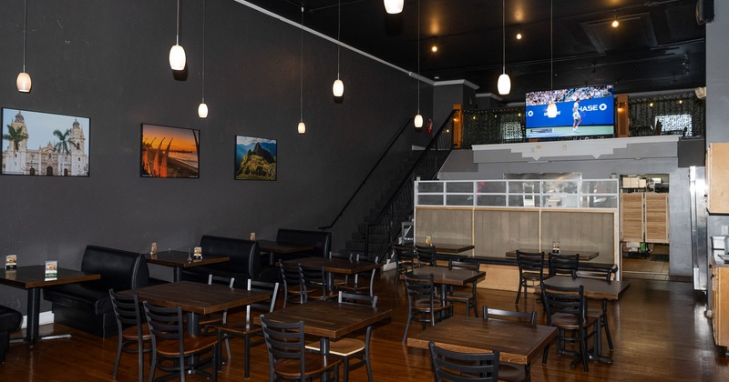 Spacious interior dining area on the ground floor with stairs leading to an upper dining area