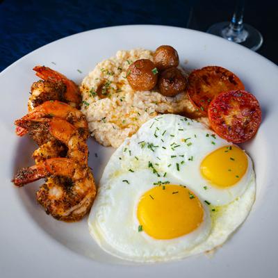 Loaded grits with shrimp and two eggs.