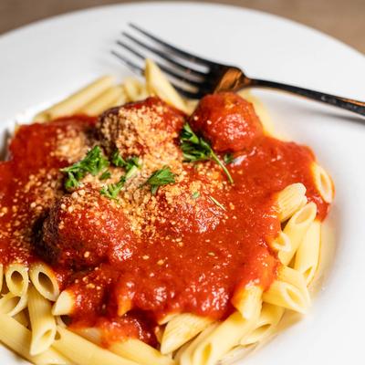 Meatballs and pasta with a tomato based sauce.